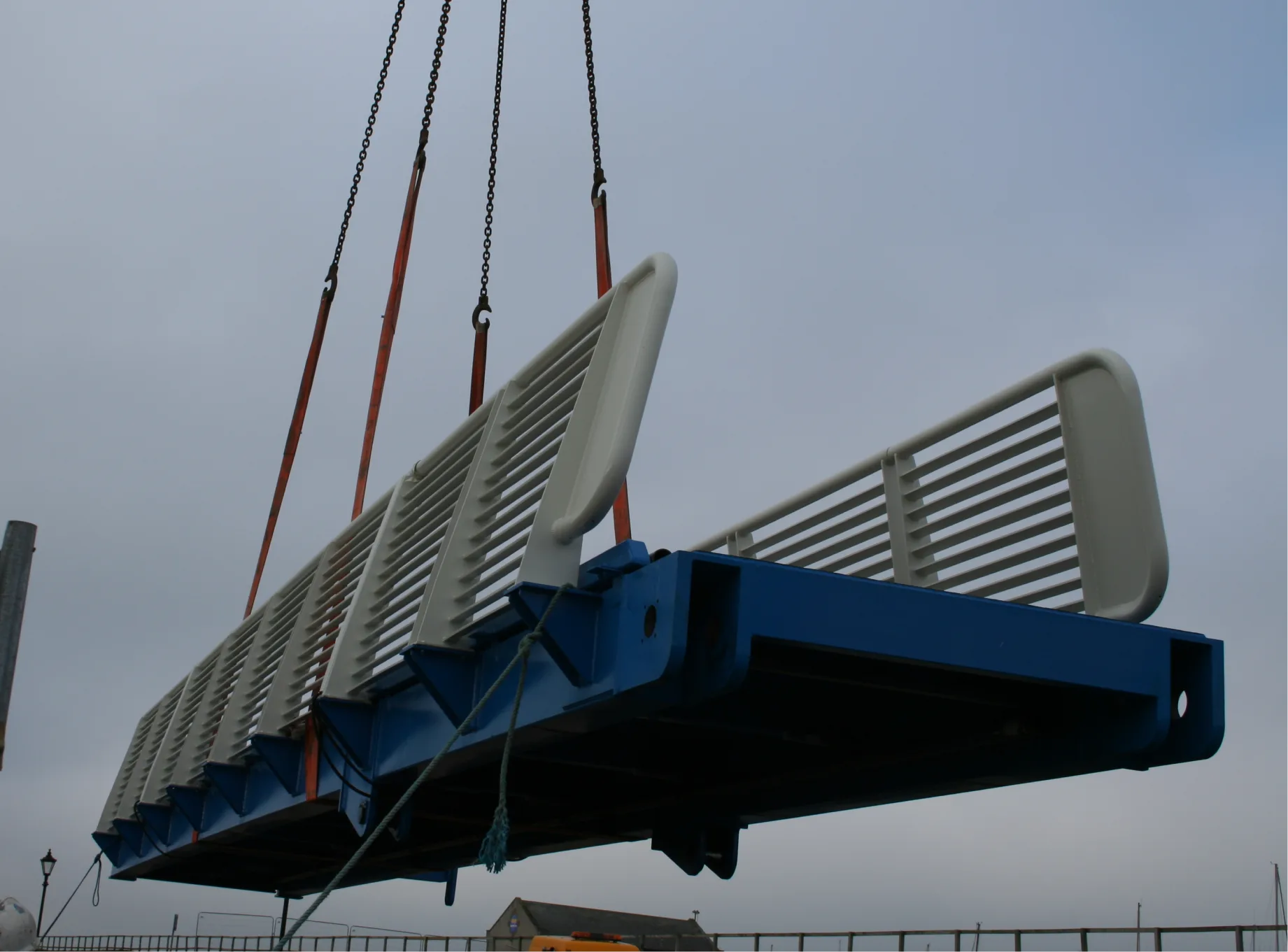 The walkway of the Maryport Articulated Bridge being lifted by a crane