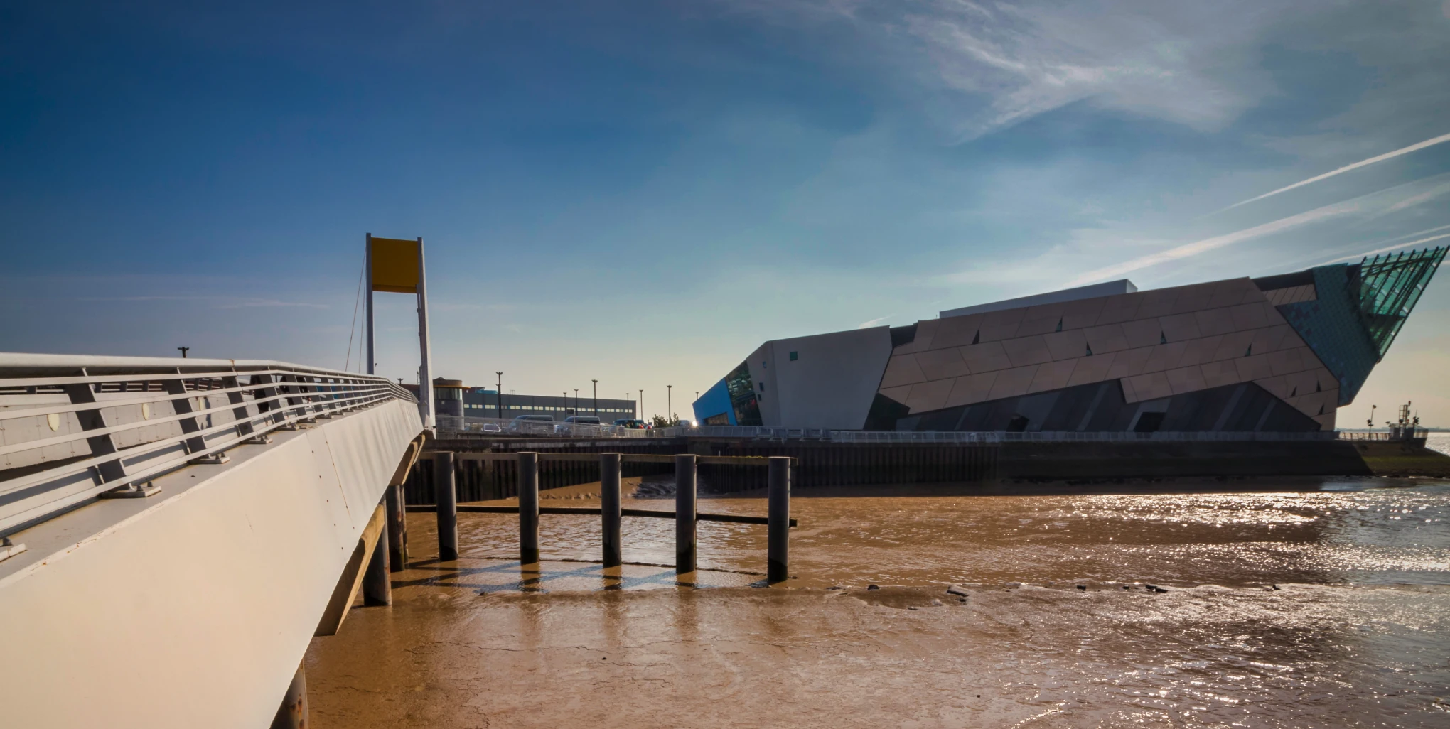 Shot from the side of the Deep Rotating footbridge with both the footbridge and the Deep in the image