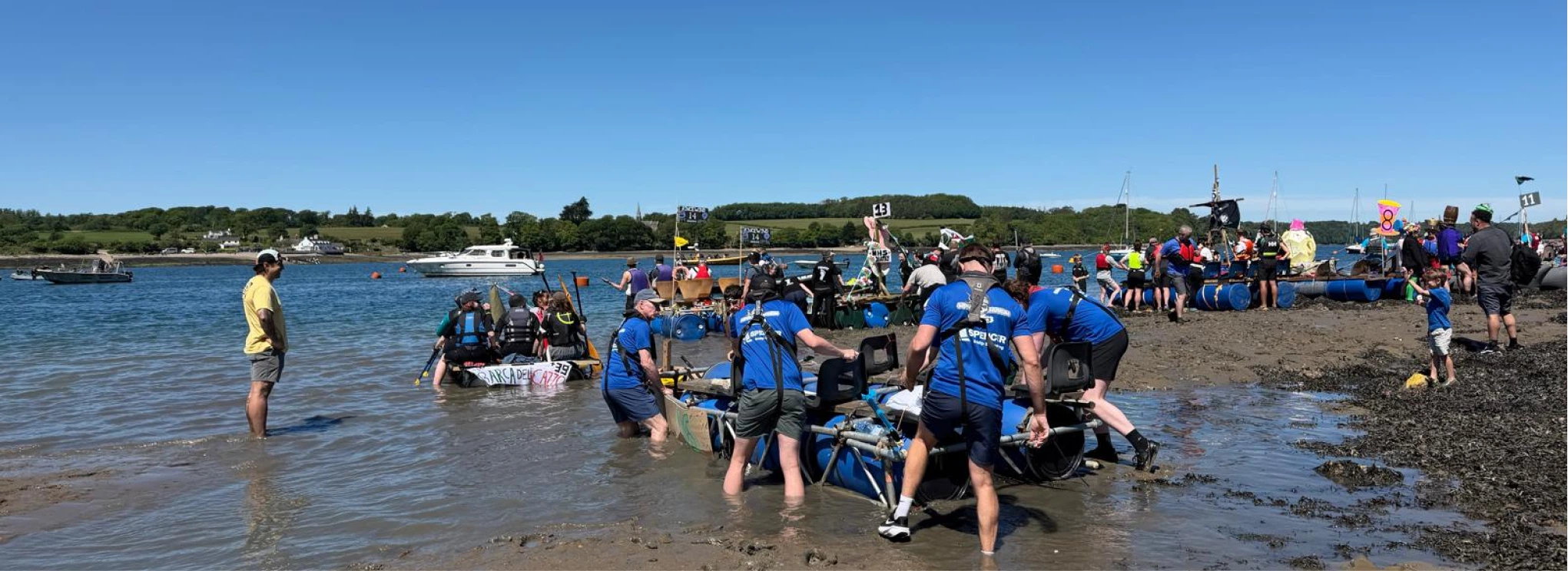 Image of some of the Spencer Bridge Engineering colleagues pushing out their raft to take part in the Great Strait Raft Run in Anglesey to raise money for the Menai Heritage Museum.