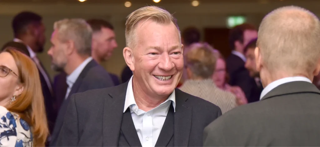 Member of the Spencer Bridge Engineering team laughing with another individual at the Scottish Civil Engineering Awards event